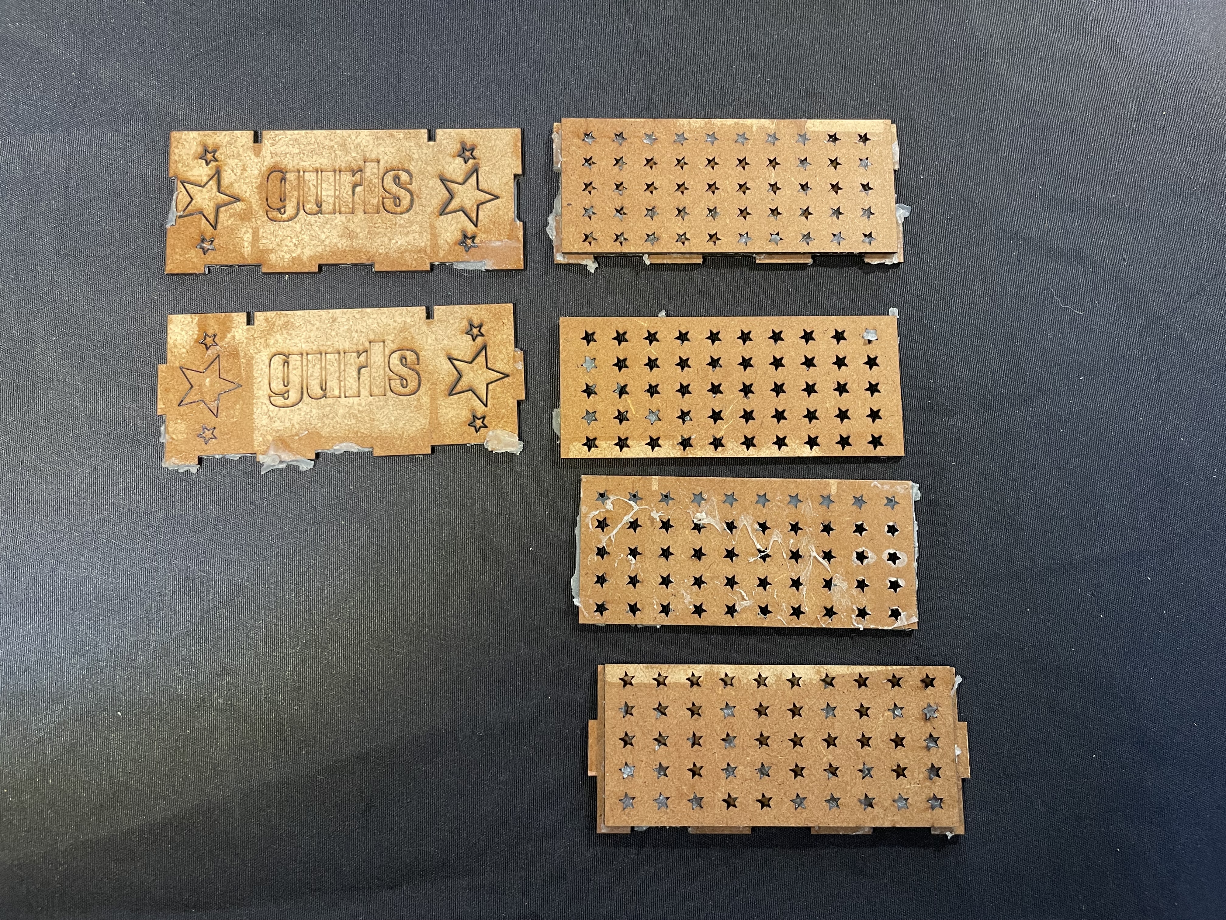 Laser cut test panels with star perforations and engraved text.