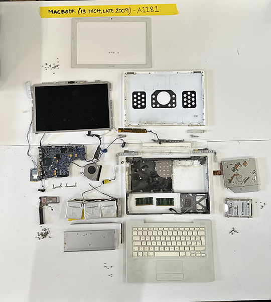 Unpacked MacBook with its internal components laid out.